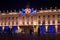 View of the colorful illuminated historical building of the Hotel de Ville in Nancy at night.