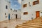 View of colorful plant pots, windows, on a typical house white wall, the Kasbah of the Udayas, in Rabat, Morocco.