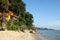 View on the colorful small wooden houses on the rocks near to the sea between jungles on a background of rainforest.