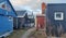 View of colorful village cottages under a cloudy sky