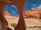 View of the colourful rocks through a rock hole