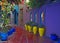 A view of a Colourful terrace with yellow pottery containers in a decorative garden in Marrakech