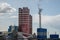 View of a complex of industrial buildings with smoking chimneys in the afternoon against the sky with clouds