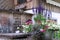 View of the composition of flowers in a tin basin on the background of the house