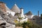 View of the conical dry stone roofs of a group of traditional trulli houses in Alberobello in Puglia Italy