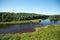 View of the coniferous forest and river in summer in the North of Russia.