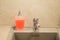 View of a container of liquid soap on a gray kitchen sink, clean house