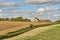 A view of a converted barn and farmland in late summer.