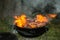 View of cooking fresh meat on char coal barbeque burning in flame