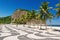 View of Copacabana and Leme beach with palms and mosaic of sidewalk in Rio de Janeiro