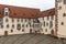 View of a corner of the backyard of the Hohes Scloss castle in Fussen on a cloudy winter day, with beautiful painting on facade,