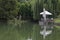 View of a cosy relaxation area under awnings with tables and chairs on the shores after rain of Lake Ariana, Borisova Gradina Park