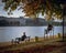 View of a couple and a man sitting on the riverside benches of a park in Copenhagen