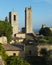 View of a couple of towers in San Gimignano, Italy against blue sky, taken from the Parco della Rocca