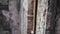 View through a crack in the floor to the second floor of an abandoned factory. Broken buildings