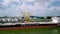 View of a crane vessel in the port of Rotterdam under cloudy sky