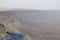 View of the crater from the rock. National park HaMakhtesh Mitzpe Ramon. danger road. Negev,Israel