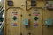 View on the cream metal doors with warning stickers for gas bottle store of oxygen and acetylene bottles.