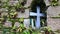 View of cross and icons at old stone wall niche