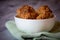 View of crunchy coconut cookies in a white bowl