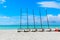 View of Cuban Varadero beach and tranquil turquoise ocean with catamarans sitting on sand