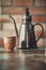 View of a cup of coffee and Pouring Kettle , brick background, C