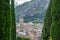 View between cypresses and mountains of the Majorcan town of Pollença (Spain)