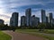 View of David Lam Park in Vancouver downtown at False Creek with people enjoying the afternoon sun and high-rise buildings.