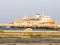 A view of a decommissioned passenger ship, standing in a scrapyard