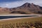 View on deep blue lake at Altiplanic Laguna Lagoon Miscanti in Atacama desert with partly snow capped cone of volcano
