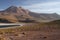 View on deep blue lake at Altiplanic Laguna Lagoon Miscanti in Atacama desert with partly snow capped cone of volcano