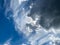 View into deep blue sky with stratocumulus and cirrus clouds on windy day announcing occasional summer rain showers