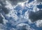 View into deep blue sky with stratocumulus and cirrus clouds on windy day announcing occasional summer rain showers