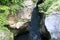 View of deep Khadzhokh Gorge with white rocks in summer