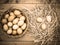 View of desaturated sepia effect, basket of fresh chicken eggs, just taken from the chicken coop on a wooden board with hay