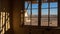 View of the desert and a house through on of the neglected window frames of a house at the ghost town of Kolmanskop, Namibia