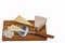 View of different kinds of cheese with cheese knife isolated on wooden board.