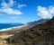 View on difficult to access golden sandy Cofete beach hidden behind mountain range on Fuerteventura, Canary islands, Spain