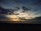 the view of a dim yellowish sunset on a quiet beach