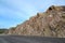 View of the dirt road in development of mountain rocky breeds. K