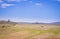 View of a dirt road between vast open agricultural livestock field, Cape Town