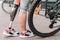 View of disabled sportswoman with bicycle on street