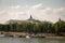 A view from a distance of the Grand Palace and the embankment of the Seine on the opposite bank against the blue cloudy sky