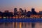 View of the Dnepr city in winter evening, lights reflected on the frozen river Dnieper, Ukraine.