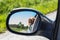 View of the dog in the rearview mirror of the car. Dog looking out the car window. Hungarian pointer Vizsla.