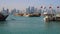 View on Doha Modern City Skyline. Day Shot, Qatar, Middle East. Traditional Wooden Qatar Boats with Qatar Flags at