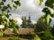 View of the dome of an old wooden church in the middle of rural landscapes