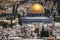 View of Dome of the Rock centered amongst housing and Christian churches