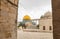 View of the  Dome of the Rock mosque and the Grammar Dome - Office of Chief Judge between the columns of the tunnel running along