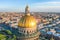 View of the dome of St. Isaac`s Cathedral and the historic part of the city of St. Petersburg and the reflected golden evening